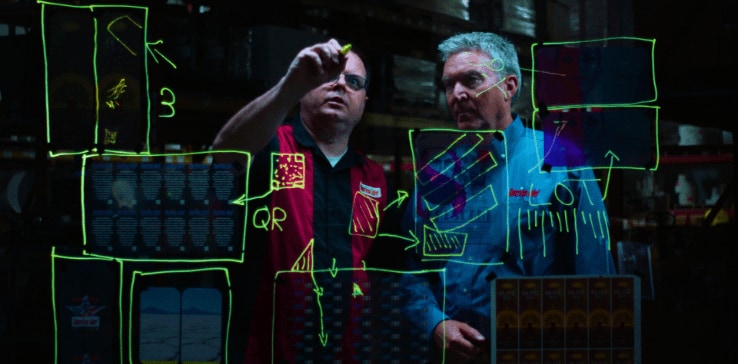 Men looking at a screen with a marker Men looking at a screen with a marker