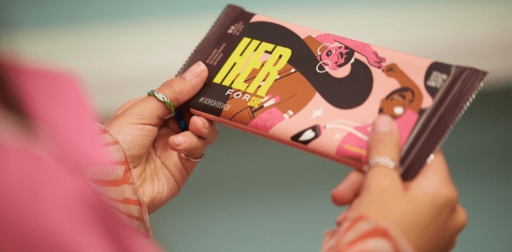 A close-up of a person holding a chocolate bar A close-up of a person holding a chocolate bar