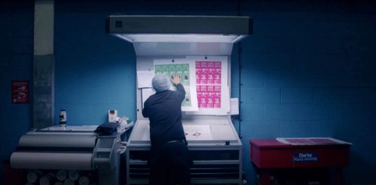 A person standing in front of a large white board A person standing in front of a large white board